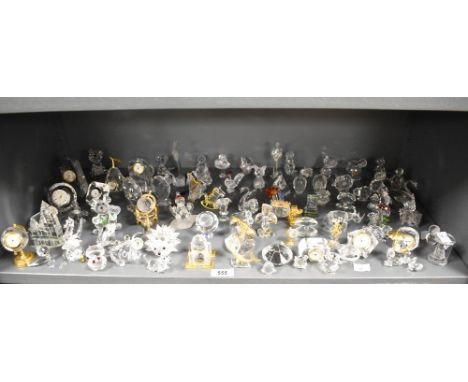 A large quantity of Swarovski crystal ornaments, various to include state carriage, globe clock, frog, hedgehog, cats, variou