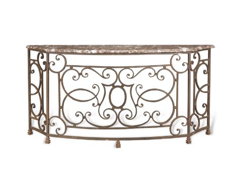 A wrought iron console tableThe bowed marble top with moulded edge above a scrolled decorated front, 196cm wide x 43cm deep x