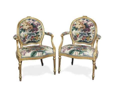 A pair of George III carved giltwood fauteuilsIn the manner of Thomas Chippendale in Louis XVI styleWith oval backs and scrol