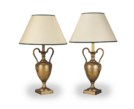 A pair of brass twin handled lamp bases in the 19th Centuy styleThe slender ovoid bodies with high scrolling mask head handle