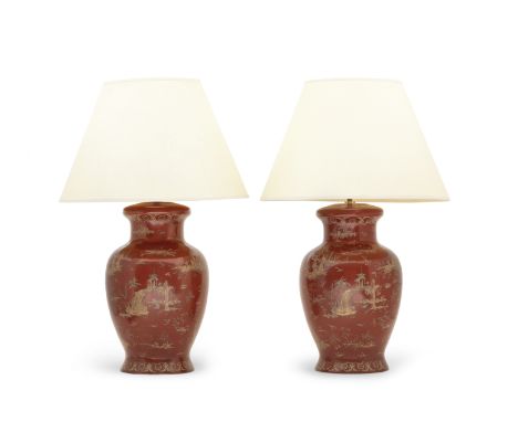 A pair of red and gilt Chinoiserie decorated lamp bases20th century Of baluster form decorated with pagodas, flowering trees 