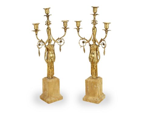 A PAIR OF EMPIRE ORMOLU AND SIENA MARBLE THREE-LIGHT CANDELABRAEarly 19th centuryEach modelled as a lady standing, issuing fo