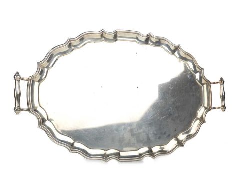 INDIAN SILVER TEA TRAY, HAMILTON & CO., CALCUTTA AND NEW DELHI, CIRCA 1959 stamped marks, of scalloped oval form, twin handle
