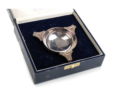 ELIZABETH II SILVER MILLENNIUM QUAICH, HAMILTON & INCHES, EDINBURGH 2000 of circular form, the triple handles with Celctic st
