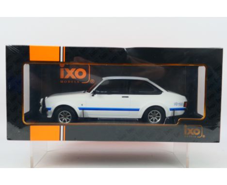 IXO Models - A boxed 1:18 scale IXO Models #18CMC029 1977 Ford Escort MK.II RS1800. The model in white appears to be in Mint 