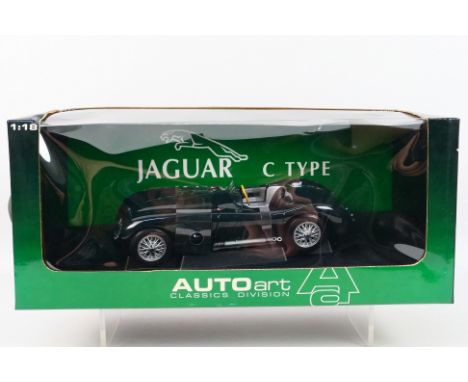 AutoArt - A boxed AutoArt #725034 1:18 scale Jaguar C-Type. The model in green appears to be in Mint condition. The window bo