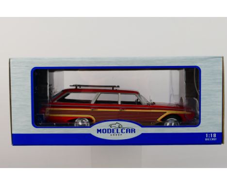 Model Car Group - A boxed 1:18 scale Model Car Group MCG18074 Ford Country Squire with roof rack. The model in red with wood 