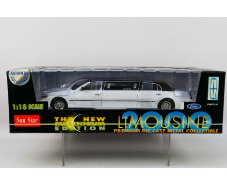 Sun Star - A boxed Sun Star 'The New Millenium Edition' 1:18 scale #1260 Lincoln Limousine. The model in white with black roo