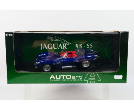 AutoArt - A boxed AutoArt #73510 1:18 scale 1958 Jaguar XKSS. The model in blue appears to be in Mint condition. The window b