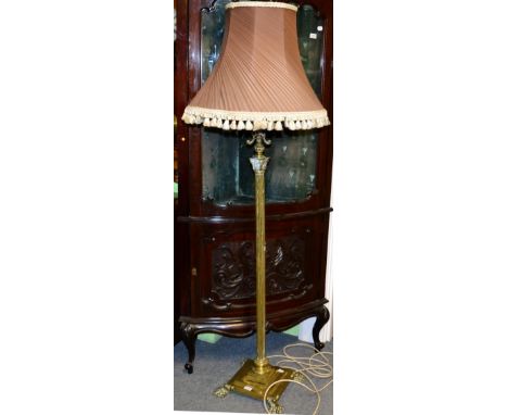 A brass standard lamp, late 19th century, modelled as a Corinthian column, the reservoir on scroll supports, on a stepped squ