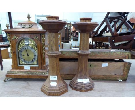 Pair of carved oak candlesticks; a gilt metal mounted oak table clock (lacking movement); and a large brass mounted writing s