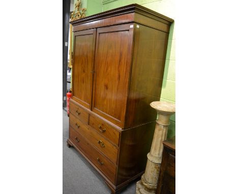 A George III mahogany linen press, the upper section containing five slide out trays, on ogee bracket feet, 201cm high by 132