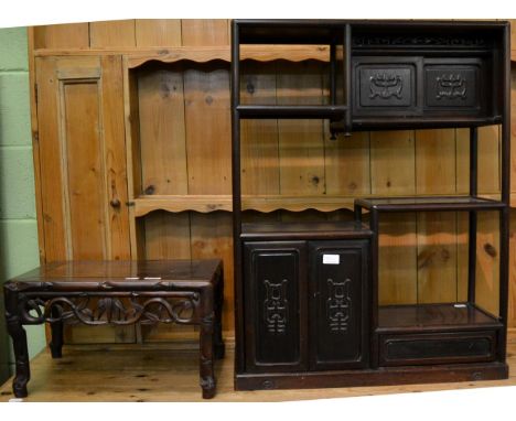 A Chinese hardwood low table together with an Oriental hardwood display shelf with an arrangement of cupboards and shelves (2