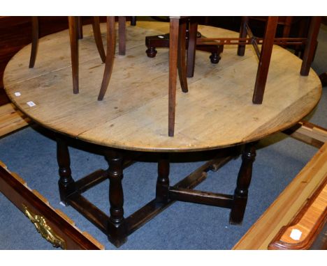 A circular oak gate leg table