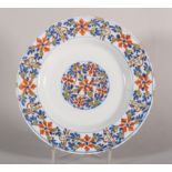 An 18th century Scottish/Lambeth? delft polychrome plate with geometric floral decoration, 9" dia [