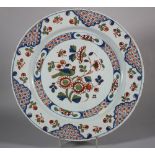 An 18th century Bristol? delft charger with bird and spray of flowers diaper and insect border, 13