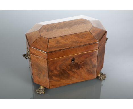 GEORGE III MAHOGANY TEA CADDY of octagonal form, with two interior compartments, on brass paw feet, 15cm high, 20cm wide 