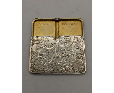 An early 20th century silver retractable stamp holder having an engraved floral case, makers mark S & Co, hallmarked Birmingh