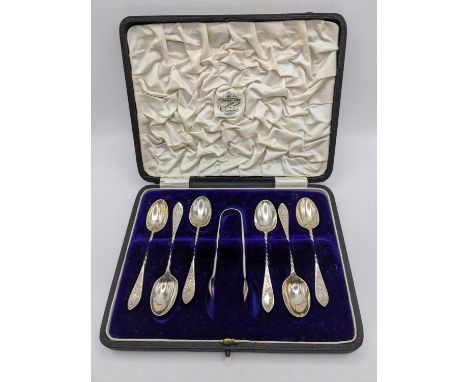 A 1920's silver cased set of six tea spoons and a pair of sugar tongs, 72.5gLocation: 