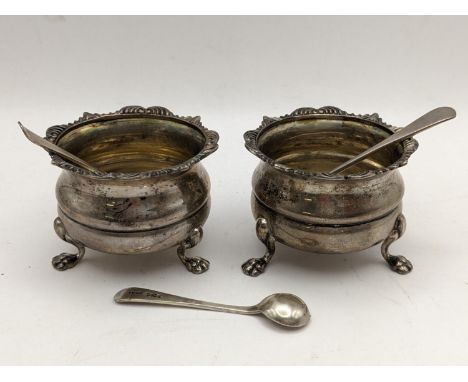 A pair of early 20th century silver salts raised on three feet together with three silver salt spoons, 83.1gLocation: 