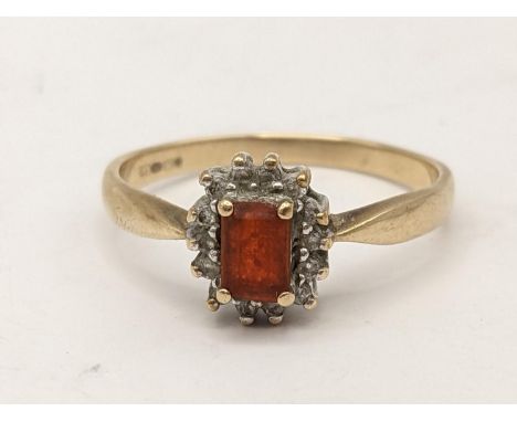 A 9ct gold cluster ring inset with an emerald cut orange coloured stone, 3gLocation: 