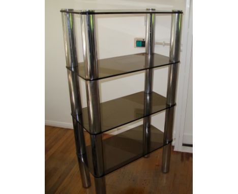 A modern smokey glass 4 shelf unit with chrome legsLocation: A2M 
