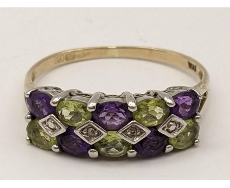 A 9ct gold ring inset with alternating purple and green stones, 2.3gLocation: 