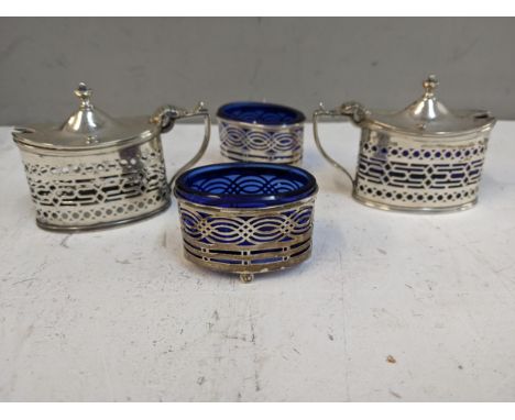 A four-piece silver condiment set with pierced decoration, one blue glass liner missing, 158g Location: 