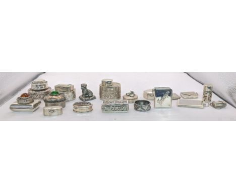 A collection of sterling silver and white metal pill boxes, some elaborately engraved and decorated with non precious stones,