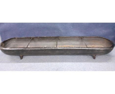 A cast iron pig trough Location: 