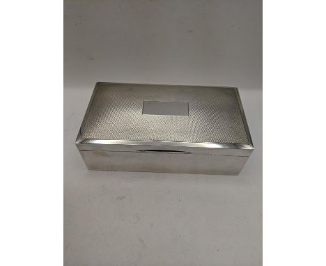 A silver cigarette box having engine turned design lid and wooden lining, hallmarked Birmingham 1974Location: 