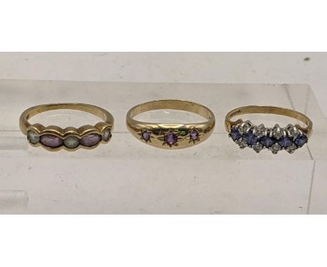 Three 9ct gold rings, one possibly amethyst trilogy gypsy ring, and two others, total weight 5.7g Location: 