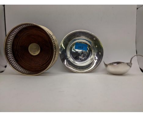 Two pieces of silver to include a wine coaster, a side plate and a white metal leaf shaped dish, weighable silver 100gLocatio