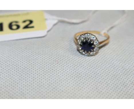 A sapphire and diamond cluster ring, the centre stone 2 carats approx. In gold but apparently unmarked. Size R