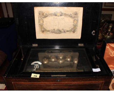A 19th Century Swiss musical box, playing 10 airs, the movement with 6 bells. 21" wide. Spring and case A.F.