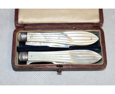 A Victorian silver and mother-of-pearl campaign fruit knife and fork. Morocco cased. Birmingham 1863