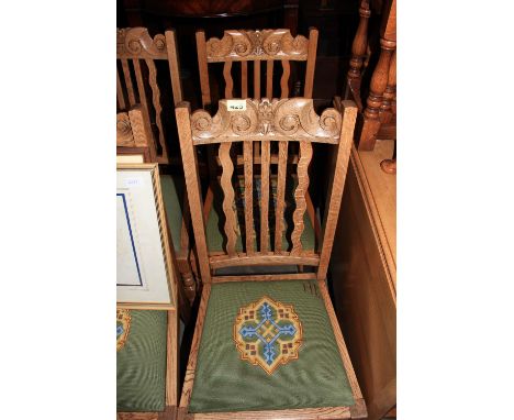 A set of eight light oak dining chairs, six with matching tapestry seats, two in calico