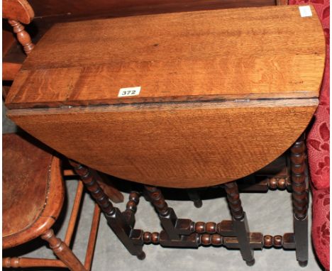 An oak bobbin turned gateleg table. 24' wide with a chair