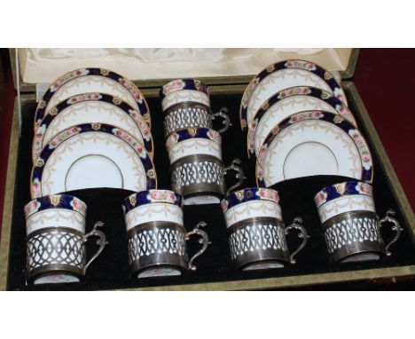 A cased set of six coffee cans and saucers with silver holders. Total silver weight 4ozs 18dwts. All coffee cans with hair cr