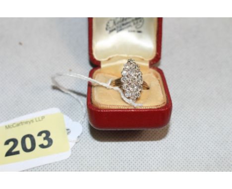 A diamond seventeen stone diamond ring, the centre stone 0.25 carat, in a navette setting. In gold. Size U