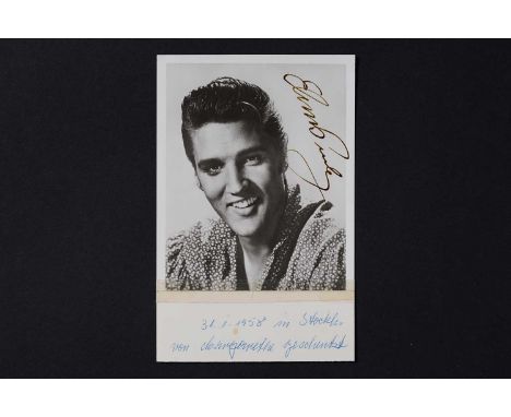 Elvis Presley (1935-1977): American musician and icon, an autograph signature, signed German UFA photographic portrait postca