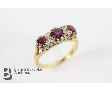 Vintage 18ct yellow gold ruby and diamond ring. The ring set with one ruby 4.5mm two others at 3.8mm x 3.2mm and approx 4 pts