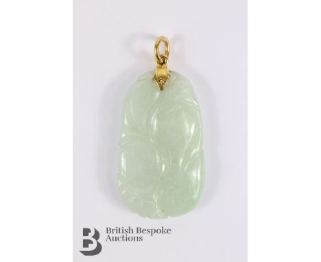 Chinese white jade pendant, with a yellow gold ring mount, the pendant carved with prunus blossom, approx 42 x 25mm, approx 1