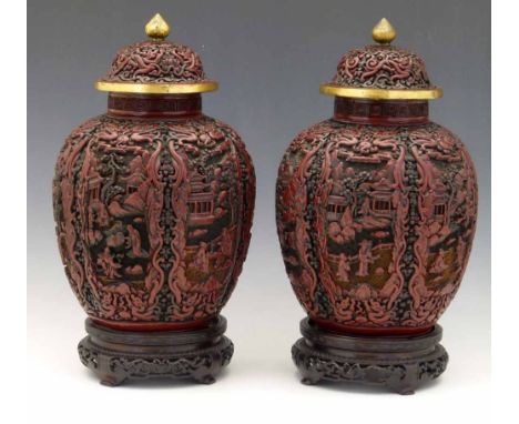 Pair of Chinese cinnabar lacquer lobed vases and covers carved with figures and pavilions, gilt copper mounts, seal mark of Q