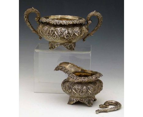 Silver milk jug and sugar basin, Charles Fox, London 1827, the compressed globular bodies embossed with foliage, 22oz.    Con
