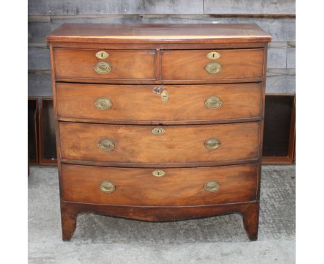 An early 19th Century mahogany bowfront chest of two short and three long drawers with oval brass handles, on shaped bracket 