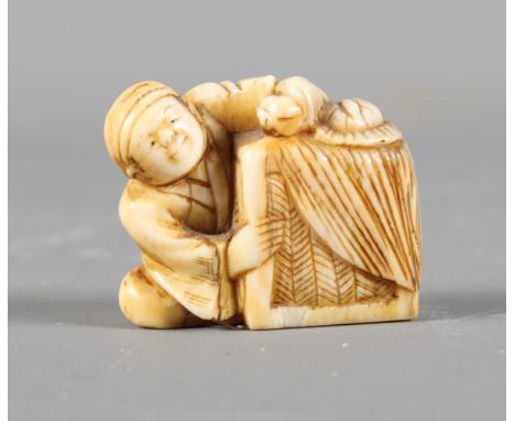 A Japanese carved ivory netsuke and a carved ivory fisherman on a chain