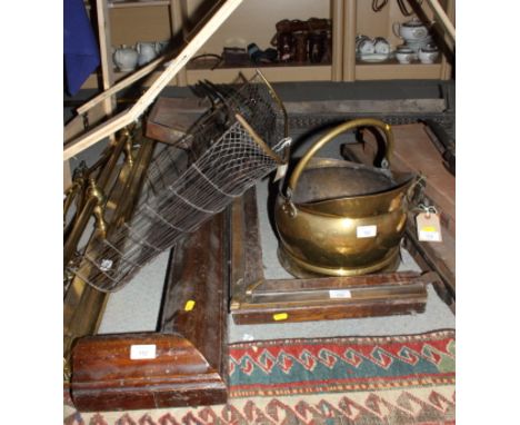 A brass helmet coal scuttle, brass chamber candlestick, a brass fireguard and three fire curbs