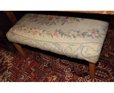 A rectangular footstool, upholstered in a floral tapestry, on short square supports, 39" x 29"