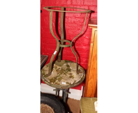 A circular metal framed garden table with circular weathered marble top (cracked) and a circular metal framed garden table ba